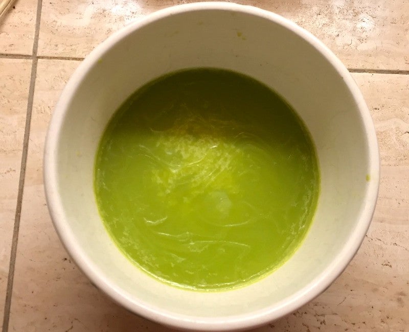 hardened canna butter in a white bowl. Butter is light green in colour.