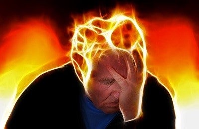 Old man with headache. Exaggerated fire is surrounding his head.