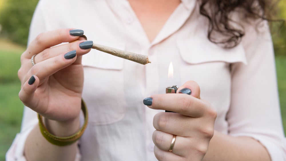 Woman lighting up a joint.