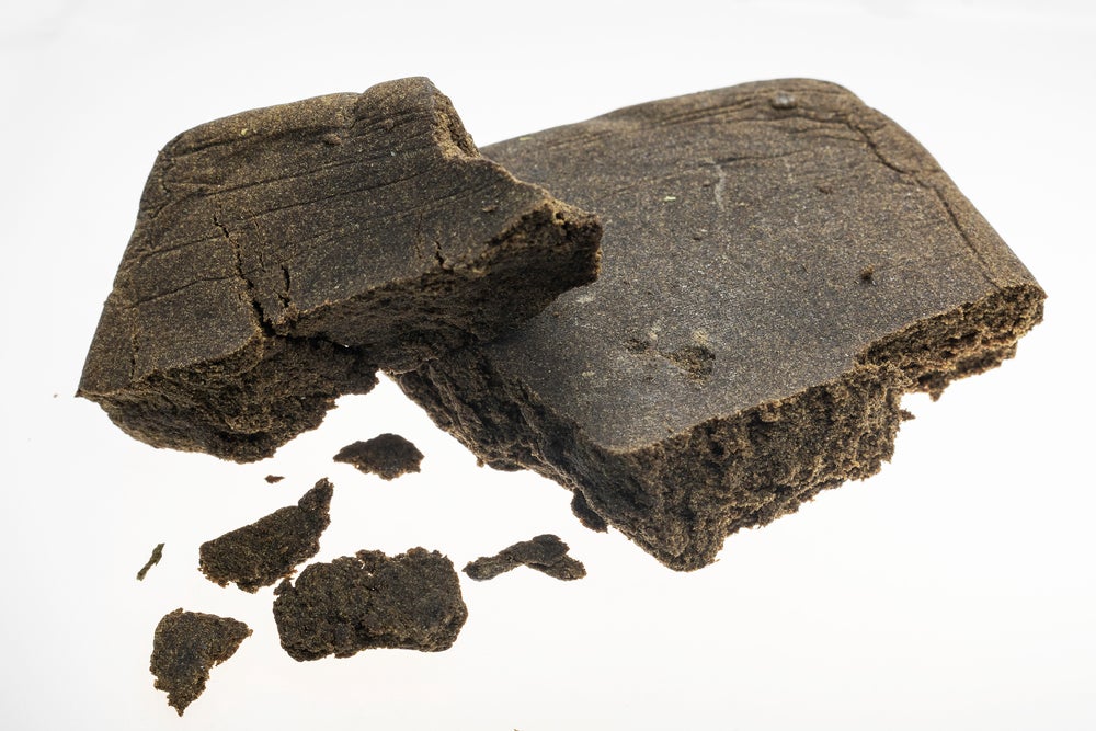 Brown Moroccan Hashish on a white background.