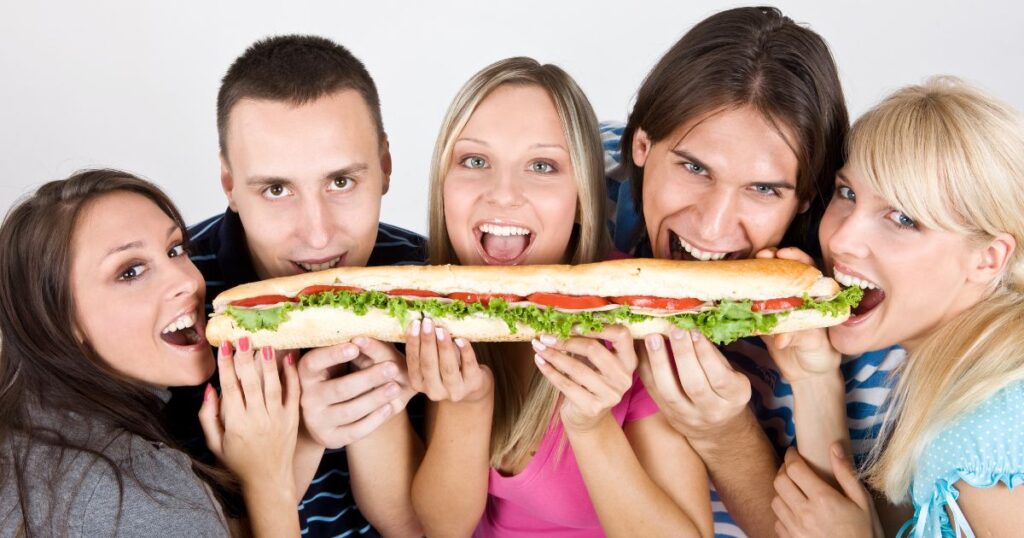 Five friends with a sandwich in their mouth.